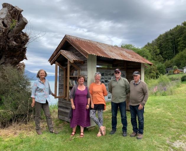Glenorchy Heritage and Museum Group committee members, from left, Amanda Hasselman, Leslie Van Gelder, Sharon Aitken, Alan Temple and John Richards with their new museum outpost at Kinloch; at left is a Lilliput library. Photo: Mountain Scene