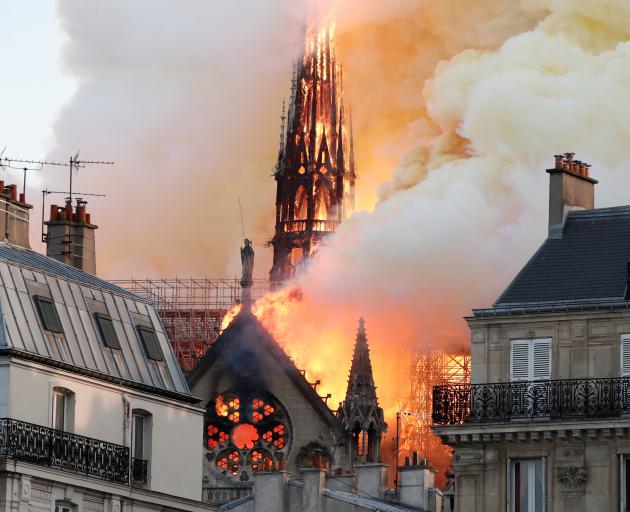 Smoke billows as fire engulfs the spire of Notre Dame Cathedral in Paris. Photo: Reuters