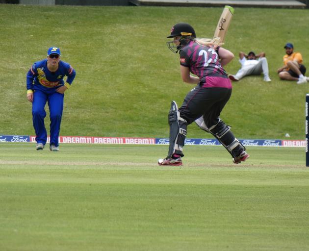 Northern Spirit opener Katie Gurry looks to score while Otago Sparks fielder Bella James awaits...