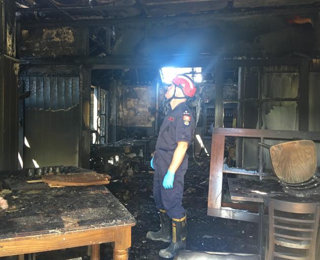 Fire investigator Mark Bredenbeck assesses damage to the communal area at Naseby’s Ancient Briton Hotel yesterday. Photo: Adam Burns