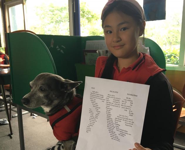 Eleven year old Isabel Wang, with rescue dog Floyd, and her shape poem for the SPCA.