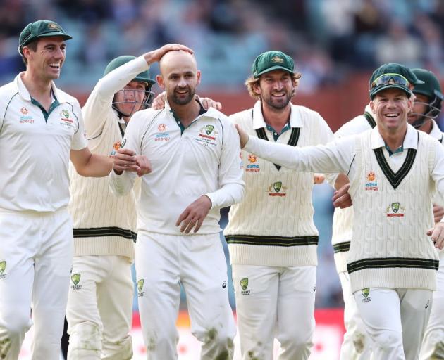 Nathan Lyon (centre) is congratulated by team mates as he helps Australia to a win over Pakistan...