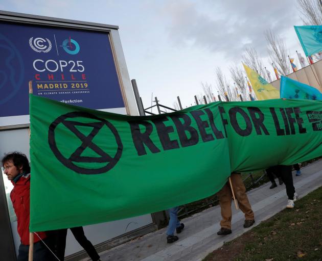 Members of Extinction Rebellion stage a protest outside the COP25 meeting in Madrid. Photo: Reuters 