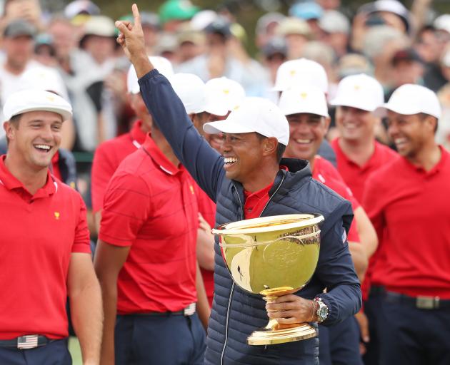 Tiger Woods celebrates winning the Presidents Cup in Melbourne yesterday. Photo: Getty Images 