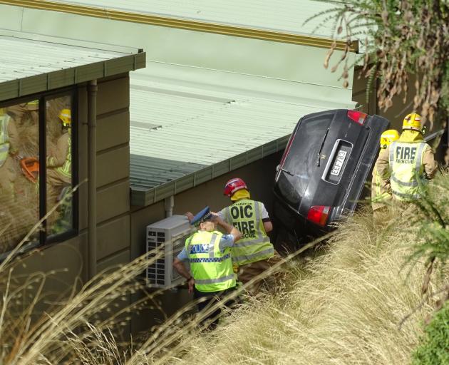 Marie Spendig was trapped in the vehicle for several hours between an embankment and a building on Gorge Rd. Photo: Tracey Roxburgh