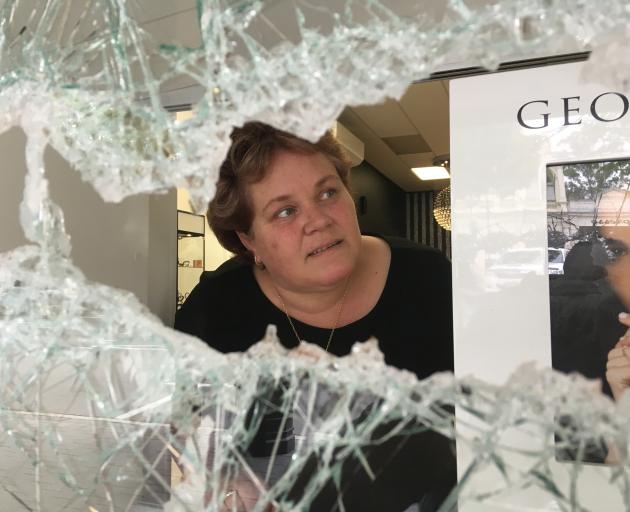 Ballantynes Showcase Jewellers owner Wendy Bradfield inspects damage to her shop in lower Thames St, Oamaru, yesterday after a front window was smashed and jewellery taken. Photo: Daniel Birchfield