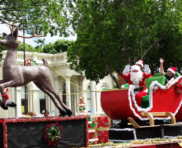 Santa waves to the crowd. PHOTOS: DANIEL BIRCHFIELD