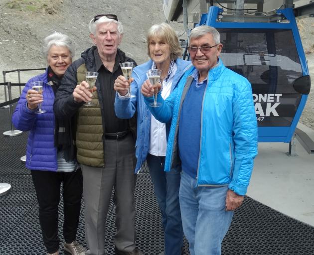 Toasting their first ride in a gondola at Coronet Peak yesterday are (from right) NZSki owner Sir...