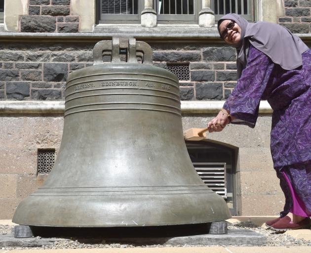 University of Otago Muslim chaplain Salmah Kassim rings the bell to mark handing in her PhD thesis yesterday. Photo: Gregor Richardson