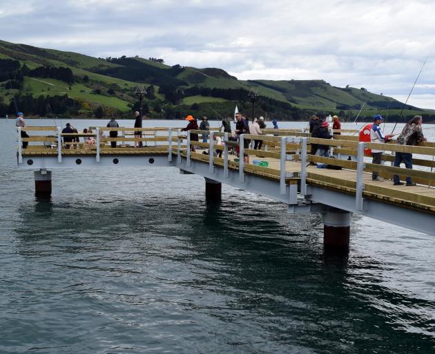 Fishers try their luck at the Boiler Point fishing jetty in Careys Bay on Sunday. PHOTO: SHAWN...