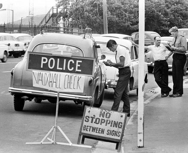 Police questioned the owners of Vauxhall cars across the South. Police officers are photographed...
