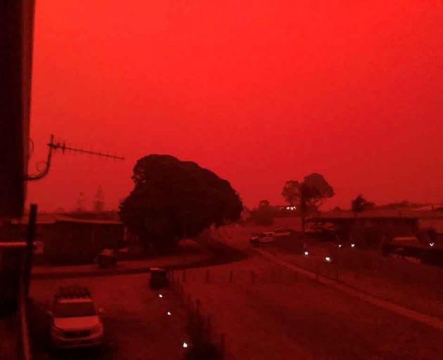 The sky glows red as surrounding wildfires close in on the town of Mallacoota, Victoria, in this...