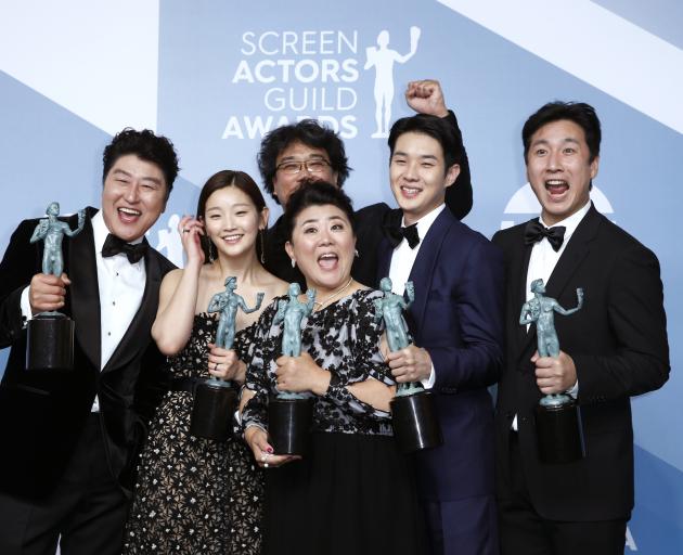 The cast of Parasite celebrate winning the SAG award for Outstanding Performance by a Cast in a...