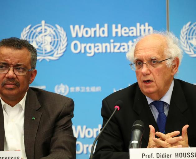 Chair of the Emergency Committee Didier Houssin speaks next to Director-General of the World...