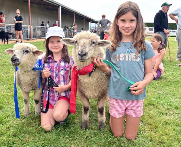 Olivia O'Neill (6, left) and her sister Mikayla (8) show off pet lamb Minty and Choc at the Otago...