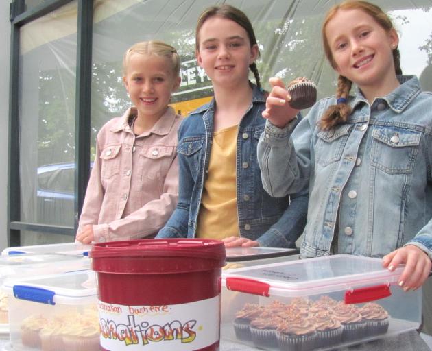 Maisie Player, 8, Piper Smith, 11, and Mya Player, 10, sell home baking in downtown Ashburton to...
