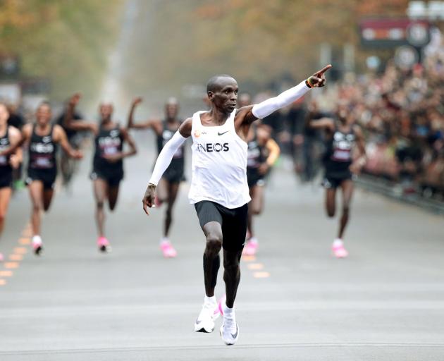 Kenya's Eliud Kipchoge, the marathon world record holder, crosses the finish line wearing Nike...