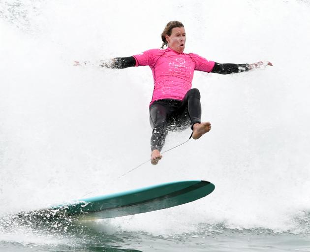 Donna Henderson, of Christchurch, leaves her board in the women’s longboard final at St Clair Beach yesterday. Photo: Peter McIntosh