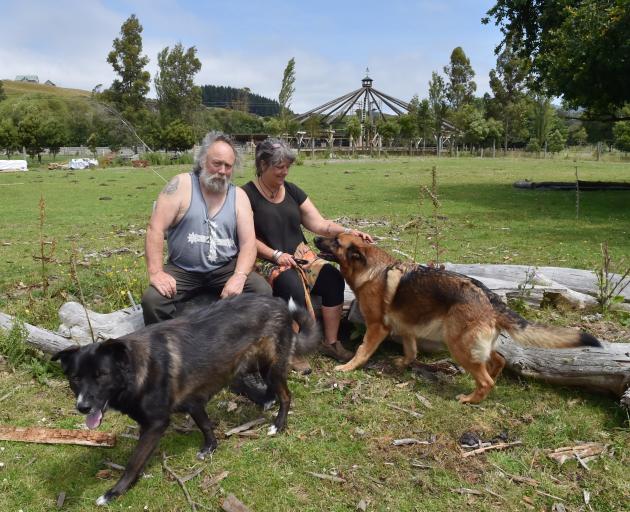 Waitati builder Mark Spencer and partner Annie Naylor, with dogs Kodi and Chiko, on the site...
