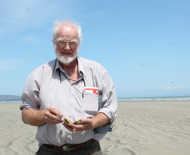 Environment Southland councillor Lloyd Esler holds a toheroa he collected in the past at Oreti...