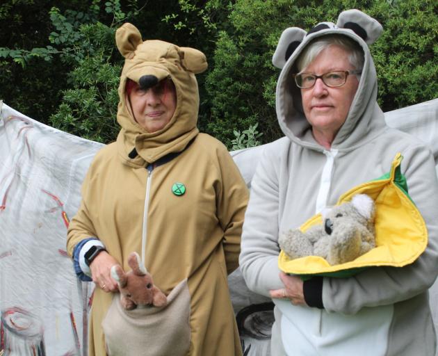 Extinction Rebellion members Lori Johnston (left) and Sandy Byers-Evitt wear kangaroo and koala...