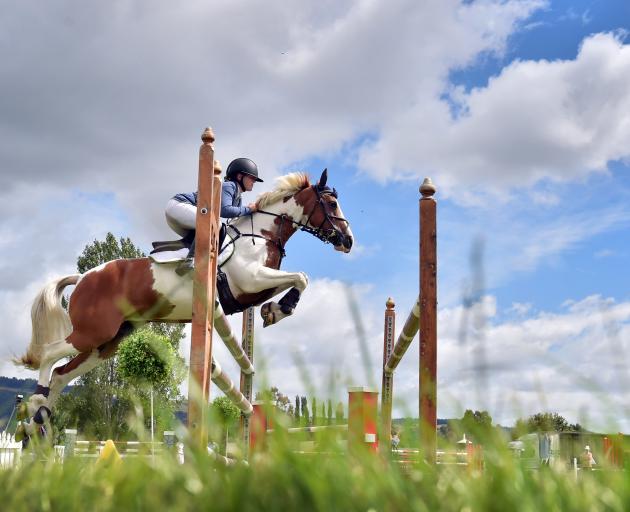 Samantha Gillies, riding Junior Disco, clears the first jump in a 120cm-130cm grand prix class in...