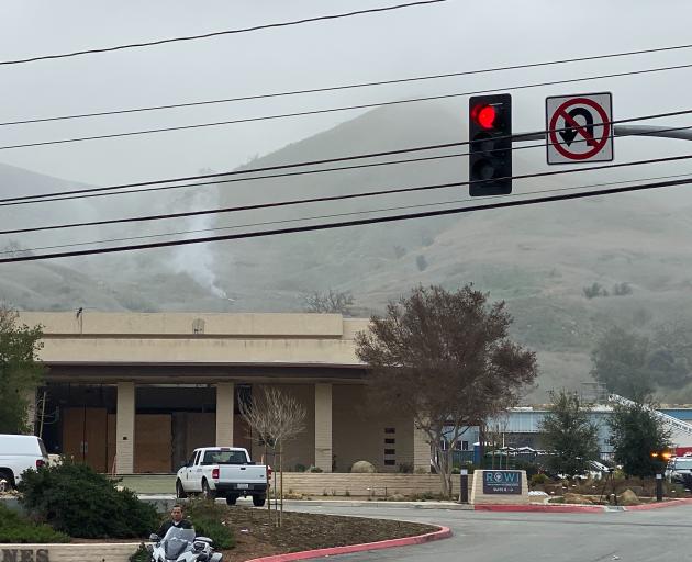 Smoke rises from the site of the helicopter crash Sunday morning, Photo: Los Angeles Times/TNS