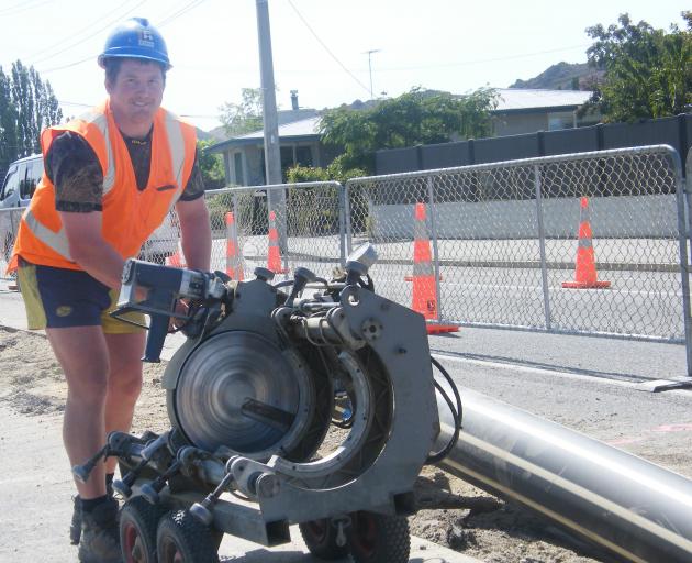 Central Otago District Council contractor Michael Harvey is all smiles yesterday as work on the Clyde wastewater pipeline in Tarbert St nears completion. Photo: Adam Burns
