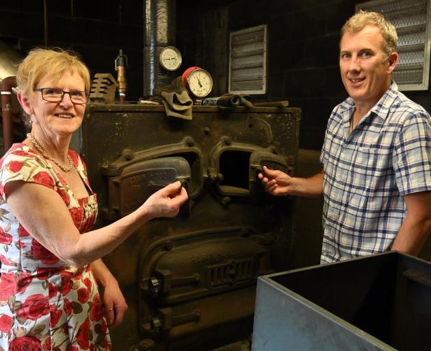 Opoho School principal Jenny Clarke and board of trustees chairman Rob Fagerlund with the school’s old coal boiler, which will be replaced with a biomass boiler. Photo: Linda Robertson