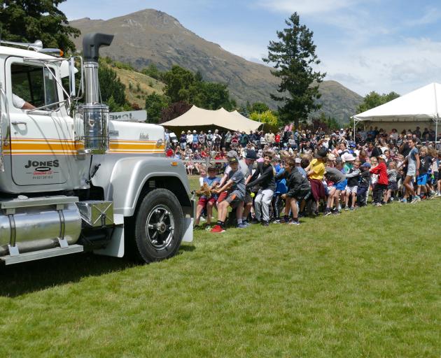 A group of children pull a 400hp Jones Contracting truck — left in neutral — at Saturday's Lake...