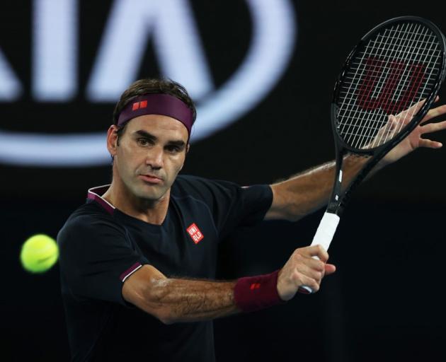 Roger Federer plays a backhand during his Australian Open match last night. Photo: Getty Images