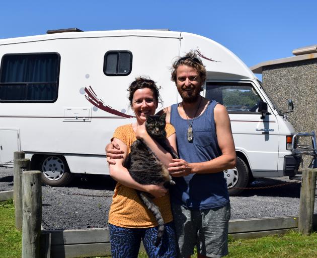 Freedom campers Sophia Christine and Nicholas Heke-Worrall hug their cat Glenny at Ocean View Recreation Reserve on Tuesday. PHOTO: SHAWN MCAVINUE