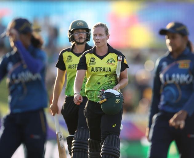 Australian batters Ellyse Perry (left) and Meg Lanning leave the field after finishing a nervy...