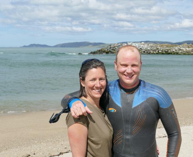Clutha River swimmer Rob Hutchings and wife and support manager Tansy Boggan, of Christchurch, celebrate his 239km swim from Wanaka at the river mouth near Balclutha yesterday. Photo: Richard Davison