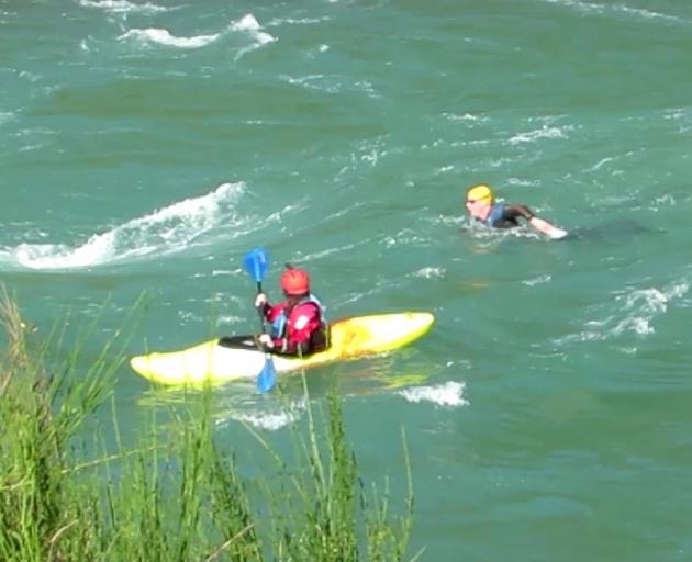 Supported by safety kayaker Laura Thomson, of Scotland, Mr Hutchings tackles rapids near Millers Flat. Photo: Tansy Boggan/Supplied