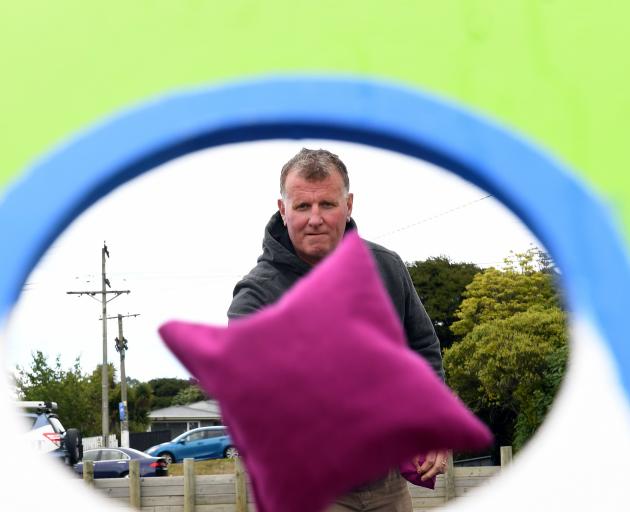 Otago Daily Times sports editor Steve Hepburn tries his luck at cornhole at the New Zealand...