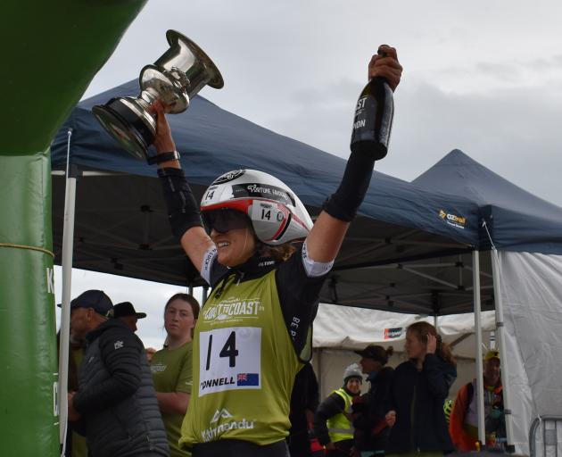 Corrinne O’Donnell raises the women’s world cup of multisport and the champagne to loud applause...