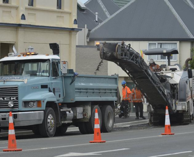 Fulton Hogan contractors use a milling machine to strip old asphalt from the surface of Great...