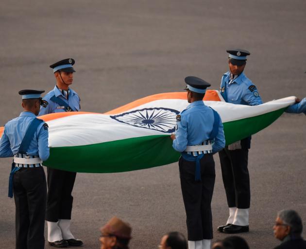 Officers with an Indian flag during the Beating Retreat ceremony in New Delhi as part of Republic...
