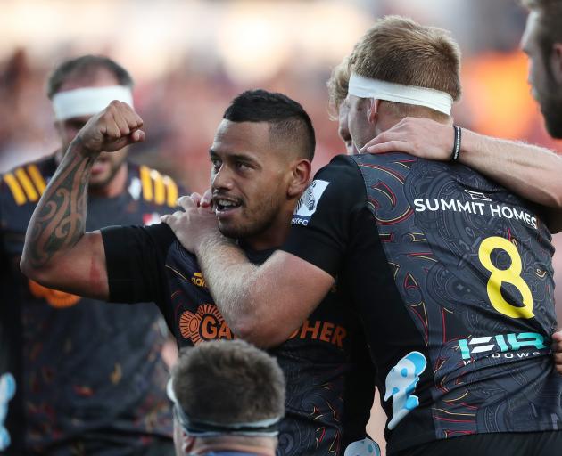 Te Toiroa Tahuriorangi of the Chiefs (C) celebrates his try during the round 2 Super Rugby match...