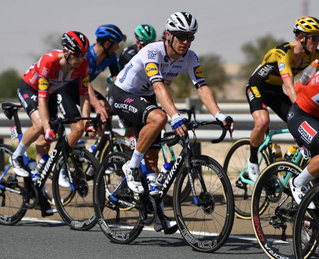 New Zealand's Shane Archbold (white shirt) competing in Jebel Hafeet this week. Photo: Getty Images 