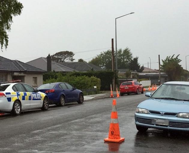 Armed police stand outside a South City property in Invercargill yesterday, where a man was found...