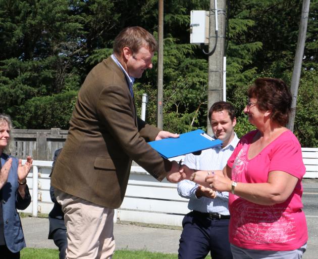 New Zealand First MP Mark Patterson presents a petition for the immediate removal of the smelter waste to Sort out the Dross spokeswoman Laurel Turnbull in Mataura yesterday. Photo: Sandy Eggleston