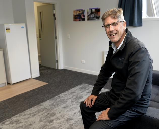 Knox College master Dr Graham Redding shows off one of the newly refurbished common rooms at the...