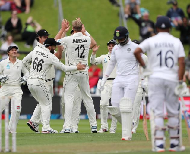 New Zealand's Kyle Jamieson celebrates the wicket of India's Cheteshwar Pujura with teammates....