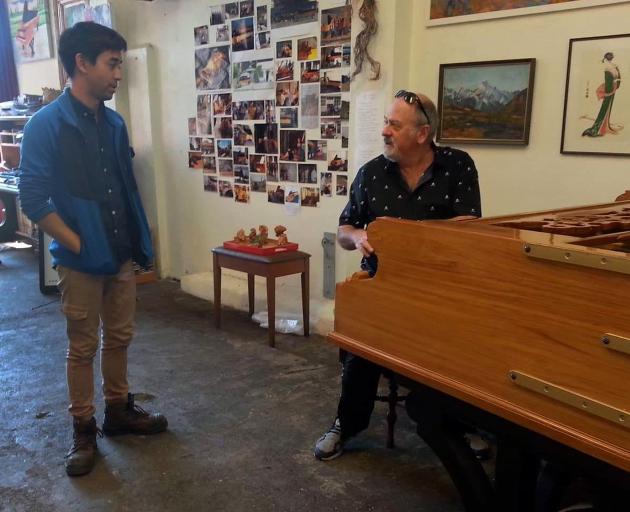Dunedin man Adrian Mann (left) was shocked when Queen’s keyboardist Spike Edney turned up to play the 6m-long piano Mr Mann made, following an email he had sent to Queen guitarist Brian May. Photo: Supplied