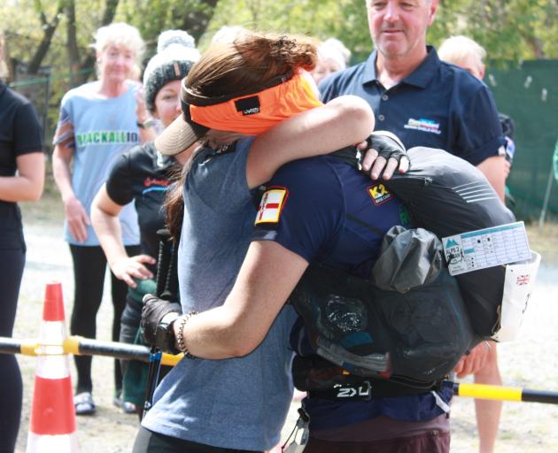 Jenny Mulholland is embraced by a supporter after finishing the longest stage.