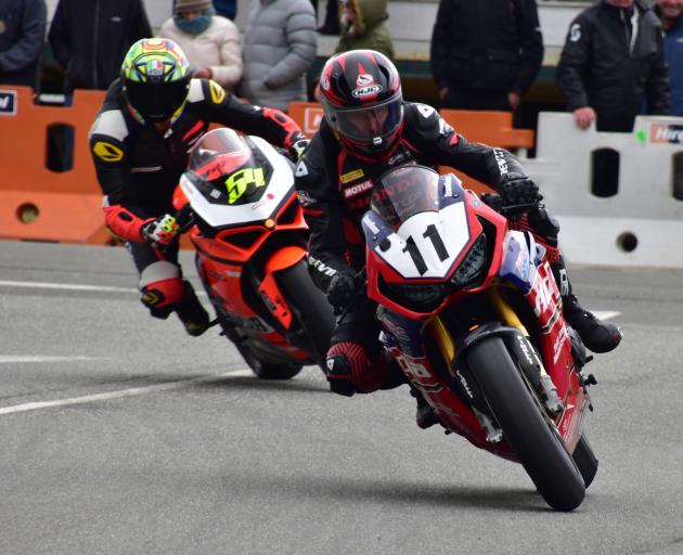 Tony Rees, of Whakatane, on his Honda CBR 1000 nudges ahead of Jonny Lewis, of Mahana, on his...