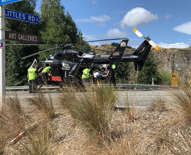 An Otago Rescue Helicopter crew picks up a cyclist at the bottom of the Coronet Peak access road...