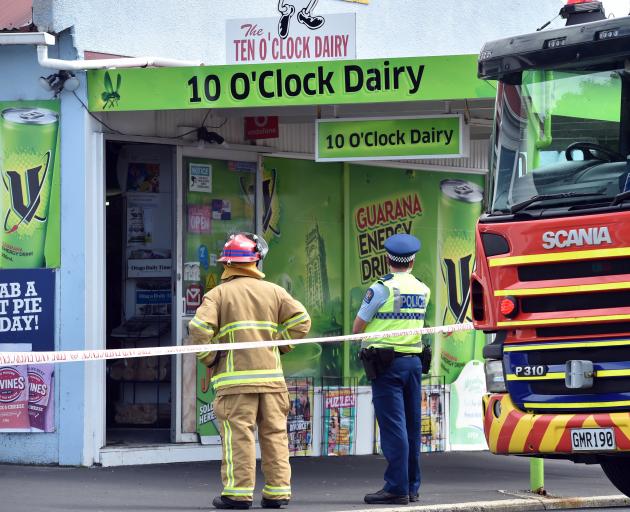 Police and fire monitor the site of an attempted robbery yesterday. PHOTO: PETER MCINTOSH
